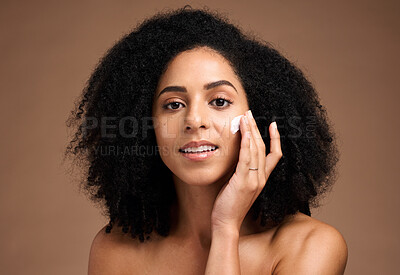 Buy stock photo Face, cream and black woman in studio for skincare, beauty and cosmetics promotion with product application in portrait. African model with skin care, dermatology and sunscreen wellness in a headshot