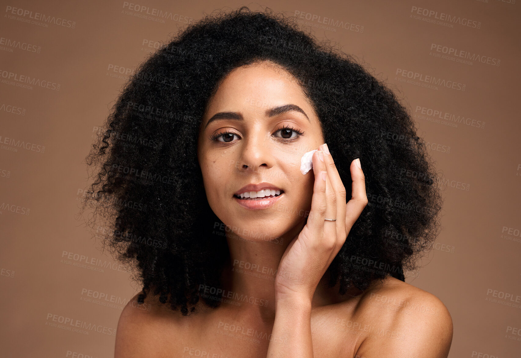 Buy stock photo Face, cream and black woman in studio for skincare, beauty and cosmetics promotion with product application in portrait. African model with skin care, dermatology and sunscreen wellness in a headshot