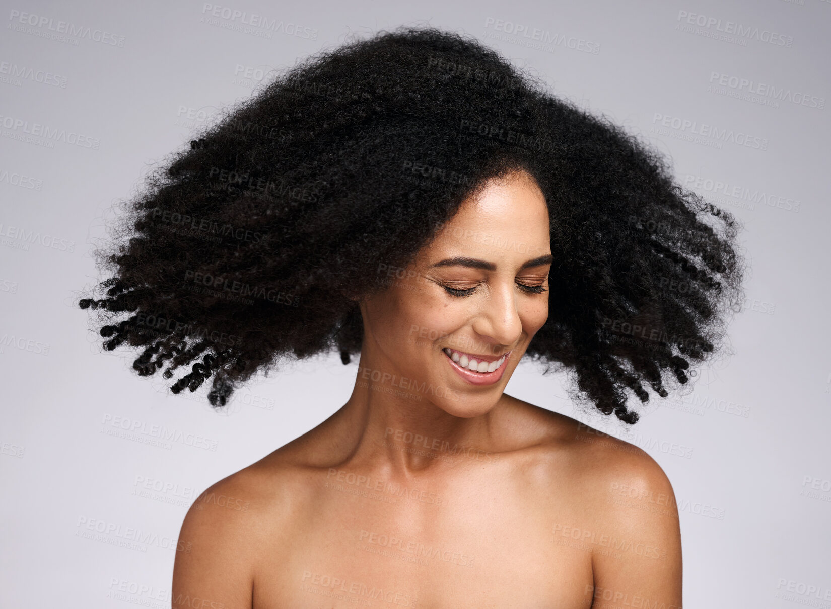Buy stock photo Beauty, black woman and afro shake for hair care campaign with playful smile and natural texture. Happiness, wellness and hair volume of african model with healthy skincare in white studio.