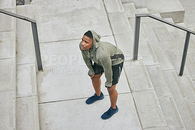 Buy stock photo Breathe, tired and sweating black man, athlete and fitness break on stairs of city workout. Top view of runner, breathing and sports fatigue on steps of training challenge, exercise or cardio running
