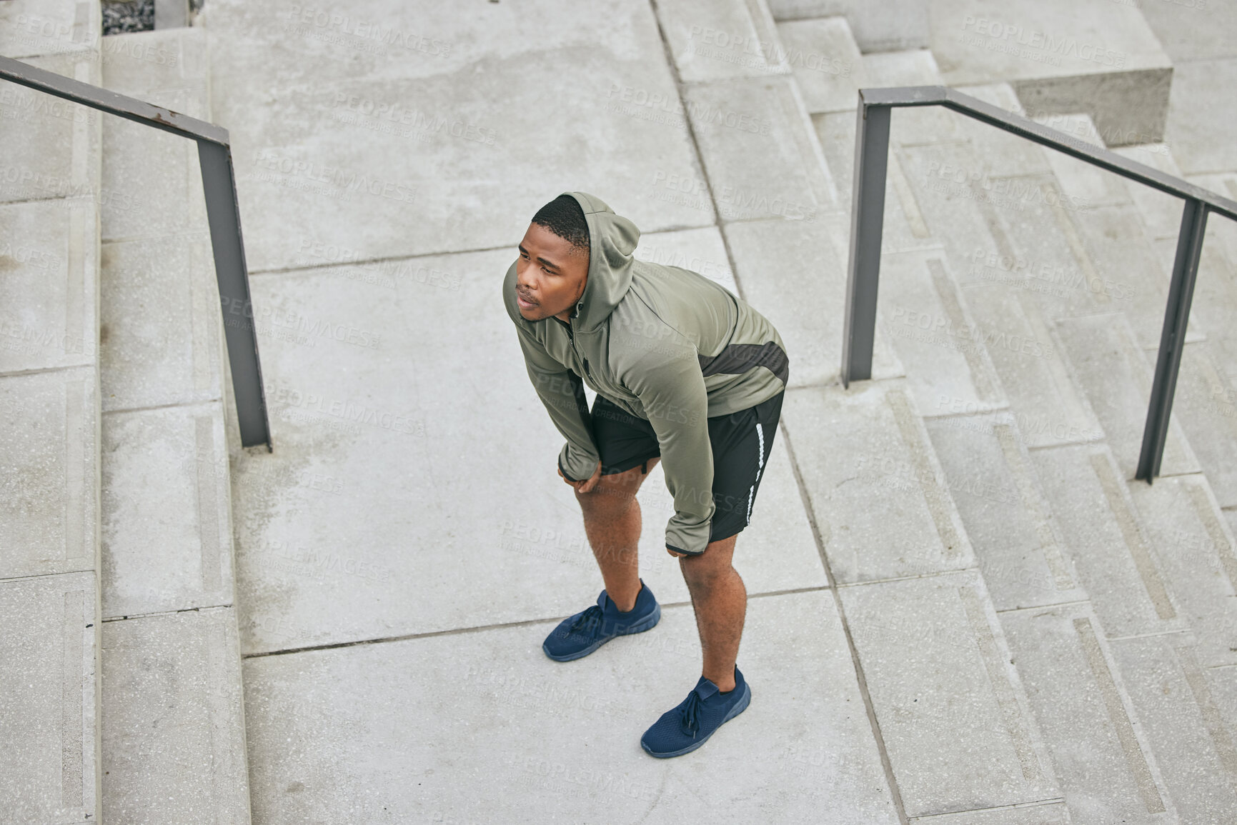 Buy stock photo Breathe, tired and sweating black man, athlete and fitness break on stairs of city workout. Top view of runner, breathing and sports fatigue on steps of training challenge, exercise or cardio running