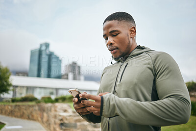 Buy stock photo Fitness, phone or black man on social media in city to relax in training, exercise or workout with in New York. Social networking, wellness or healthy athlete texting, chat or typing online on break