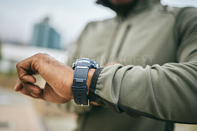 Buy stock photo Fitness, training and hand of a man with a watch for progress, exercise monitor and tracking health in Germany. Goal, performance and runner reading the time after running for cardio in the city