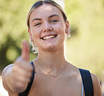 Portrait, woman and thumbs up in nature while outdoor for freedom, happiness and support for summer travel adventure. Happy young female with hand sign and backpack for motivation, peace and wellness