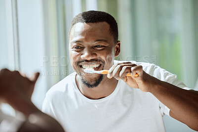 Buy stock photo Morning, black man and dental brush wellness for health, hygiene and clean smile in mirror. Self care, cleaning and oral hygiene for healthy teeth of person smiling with confidence in home.

