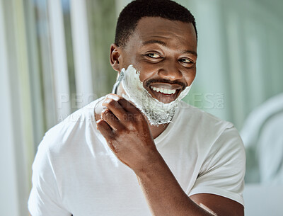 Buy stock photo Cream, razor and shaving black man in the bathroom for skincare, beard grooming routine and facial care. Smile, treatment and African person start to shave face for hair removal with foam in morning