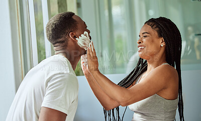 Buy stock photo Skincare, happy couple in bathroom and shaving face with at home facial product for male facial treatment. Laughing together in home, natural beauty and girlfriend helping black man with application