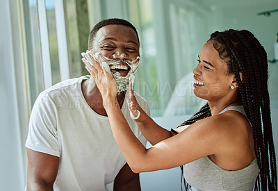 Buy stock photo Shaving, playful and fun with a black couple laughing or joking together in the bathroom of their home. Love, shave and laughter with a man and woman being funny while bonding in the morning