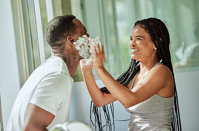 Buy stock photo Shave, playing and funny with a black couple laughing or joking together in the bathroom of their home. Love, shaving and laughter with a man and woman having fun while bonding in the morning
