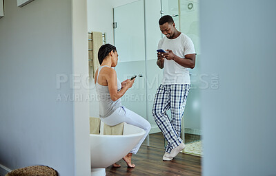 Buy stock photo Social media, app and black couple on phone in the bathroom for news, website and chat. Communication, happy and African man and woman reading funny story on the internet on a mobile in the morning