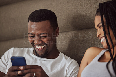 Buy stock photo Black couple, phone and relax happiness in bed for social media streaming, comic meme or quality time together reading online. African man smile, woman laughing and watching funny video on smartphone