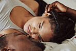 Black couple, love and bedroom romance while happy and intimate on a bed at home, apartment or hotel to relax. Face of a young man and woman in a happy marriage with commitment, trust and care