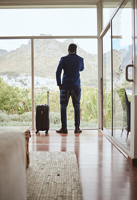 Buy stock photo Phone call, travel and businessman with a phone at a hotel for communication, connection and networking. Contact, talking and back of a black man in conversation on a mobile with luggage on a trip