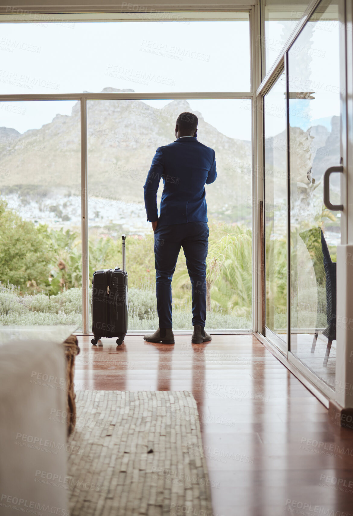 Buy stock photo Phone call, travel and businessman with a phone at a hotel for communication, connection and networking. Contact, talking and back of a black man in conversation on a mobile with luggage on a trip