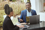 Businessman, black woman and meeting on terrace for strategy, finance goal and business trip with laptop. Business people, morning business meeting and patio with focus, collaboration and planning