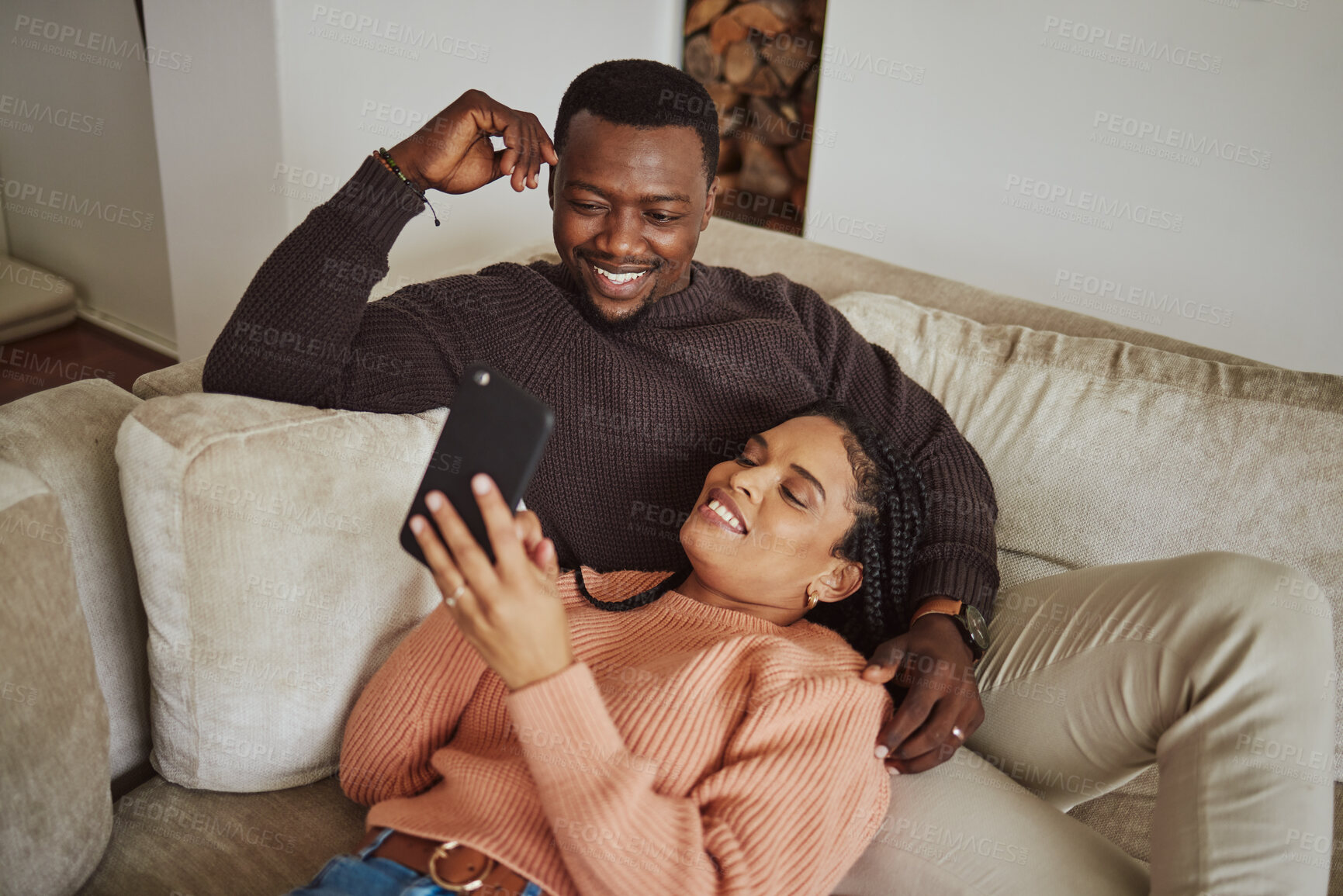 Buy stock photo Black couple, phone and lounge couch while using home wifi for streaming internet or communication. Young man and woman talking while at home for social media app, online shopping and to relax