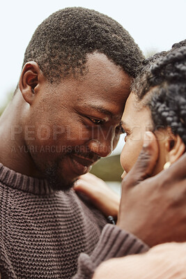 Buy stock photo Black couple, forehead and smile for love, embrace or happy relationship bonding together in the outdoors. Black man touching heads and holding woman in romance, support or hug for partnership