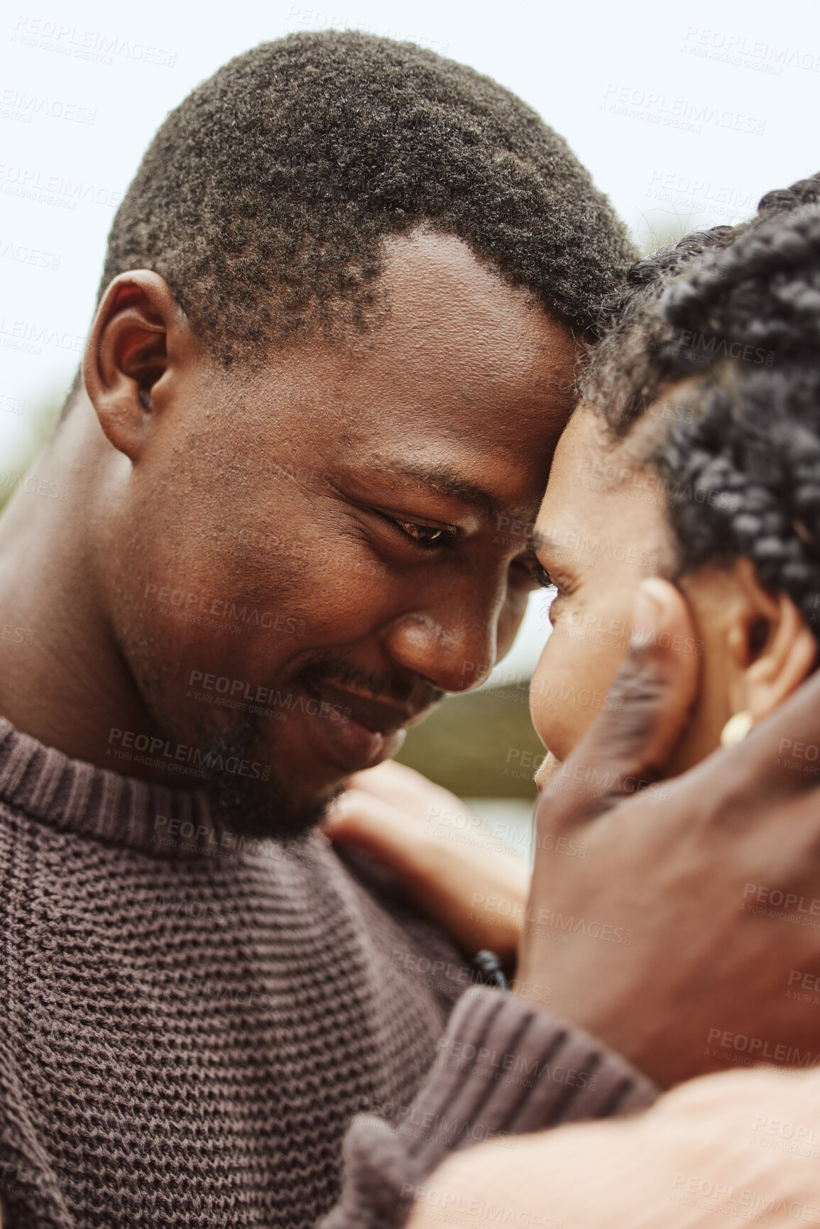 Buy stock photo Black couple, forehead and smile for love, embrace or happy relationship bonding together in the outdoors. Black man touching heads and holding woman in romance, support or hug for partnership