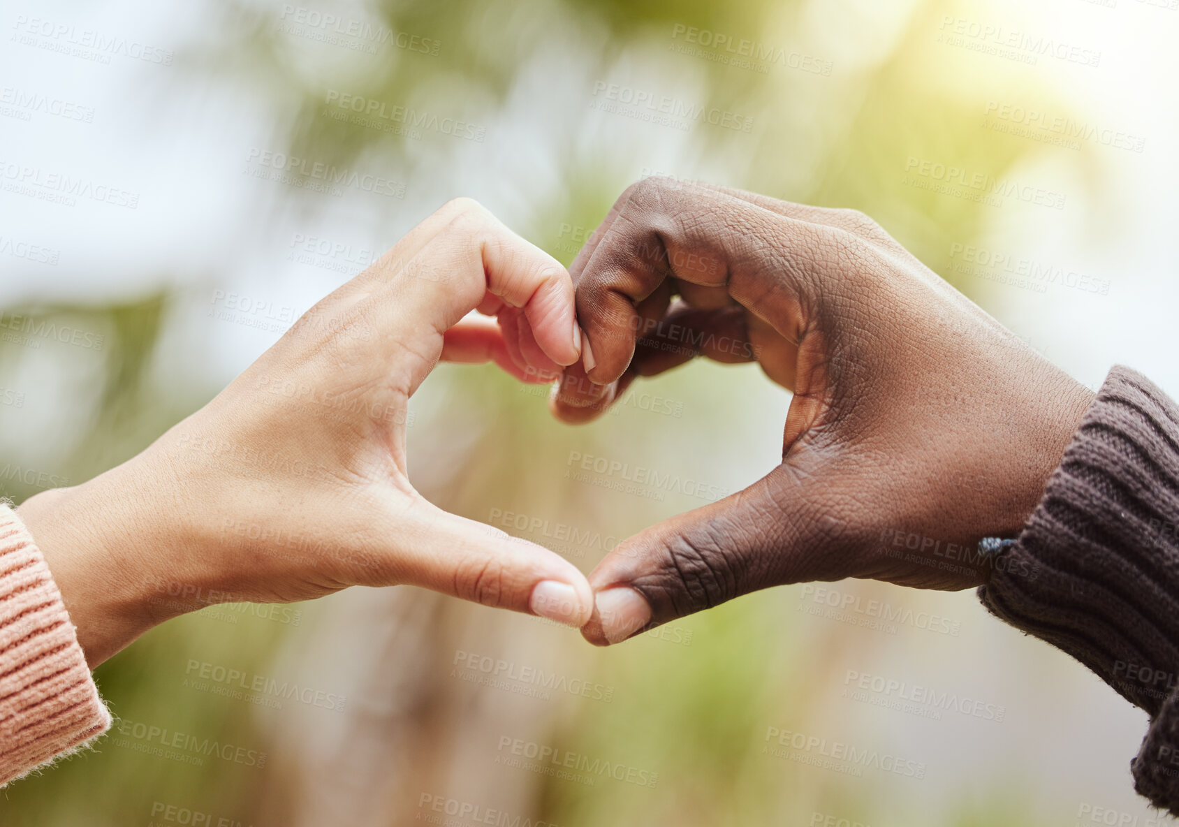 Buy stock photo Love, a couple and heart hand sign with nature, man and woman together with affection and diversity. Marriage, heart hands and a celebration of multiracial relationship with support and trust in park