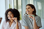 Oral care, toothbrush and female friends with a hygiene, health and wellness morning routine. Happy, smile and interracial women doing a dental treatment while brushing teeth in the bathroom.