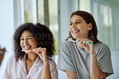Buy stock photo Oral care, toothbrush and female friends with a hygiene, health and wellness morning routine. Happy, smile and interracial women doing a dental treatment while brushing teeth in the bathroom.