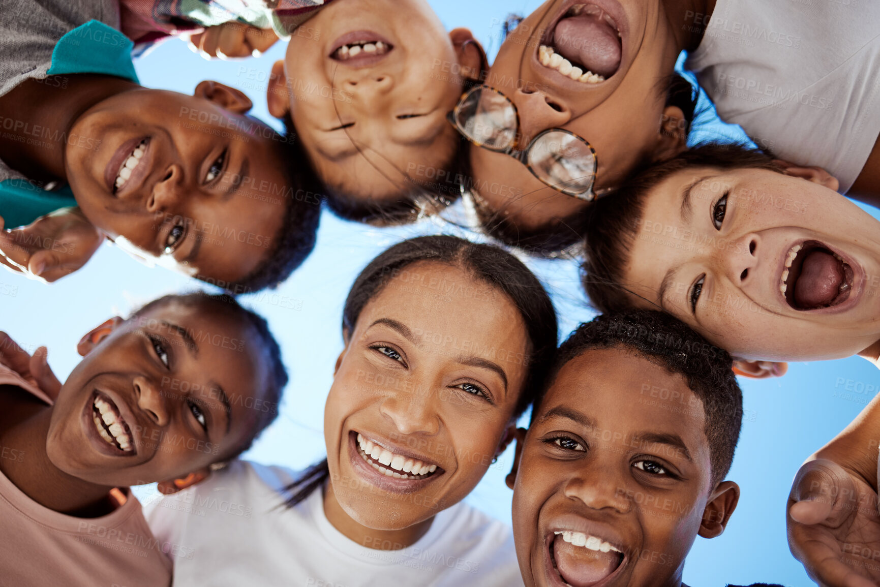 Buy stock photo Woman, children and circle of face with blue sky for community, trust and support outdoors together. Family, adoption and portrait of mother with interracial kids with smile, relaxing and happiness