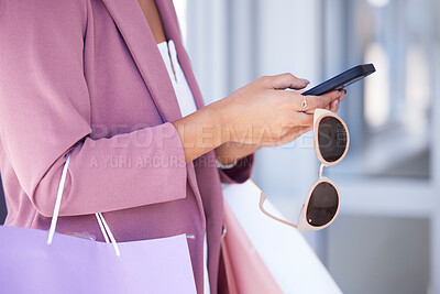 Buy stock photo Woman, phone and shopping with sunglasses in hands while doing online shopping, ecommerce and internet banking. Female using mobile app for customer discount or coupon on commerce website at a mall