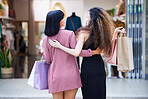 Friends, shopping and women walking in a mall together for retail therapy, sale and customer discount at a store. Paper bag, fashion and females excited for clothes, discount and commerce on travel