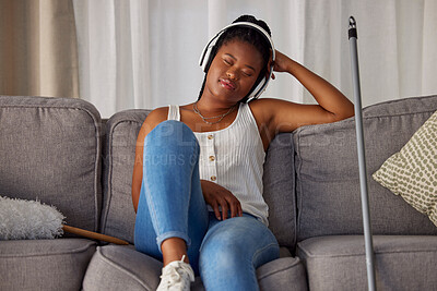 Buy stock photo Black woman, sleeping and listening to music on sofa in the living room after housekeeping, cleaning or dusting at home. African American female domestic relaxing or resting with headphones on couch