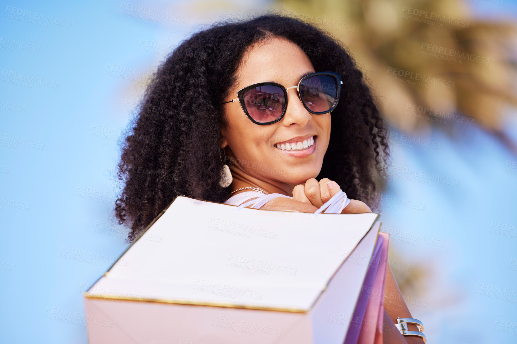 Buy stock photo Freedom, summer and girl with shopping bag portrait and smile in sunny Los Angeles, USA. Happy, consumerism and trendy black woman fashionista girl with retail bags for stylish lifestyle.

