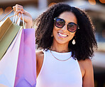 Luxury shopping and portrait of girl with gift bags and cheerful smile in sunny Los Angeles, USA. Retail, consumerism and trendy black woman happy with shopping bags for stylish lifestyle.

