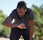 Fitness, black man and smart watch time for running exercise, workout challenge or healthy marathon training. Stopwatch, sports runner and athlete break to monitor steps count, heart rate or progress