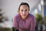 Woman runner portrait, music and earphones for motivation, outdoor workout or fitness in city. Girl, wellness and focus on face with phone, streaming online or run for training, exercise or health