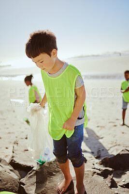 Buy stock photo Environment, cleaning and children with pollution on beach for clean up, dirt and eco friendly volunteer. Sustainability, recycle and Asian boy reduce waste, pick up trash and plastic on beach sand