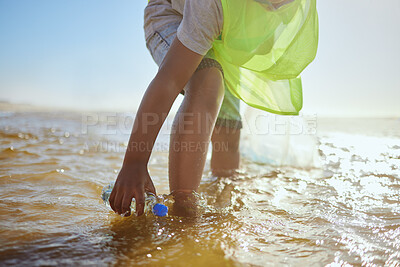 Buy stock photo Plastic bottle, cleaning ocean and kid with environment and climate change, environmental and volunteer for Earth day. Water pollution, nature and children clean up beach for eco friendly activism