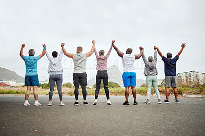 Buy stock photo Holding hands, fitness group of people winning, yes or celebration exercise, workout and training goals in city rear. Wellness, community and senior friends teamwork, accountability and success sign