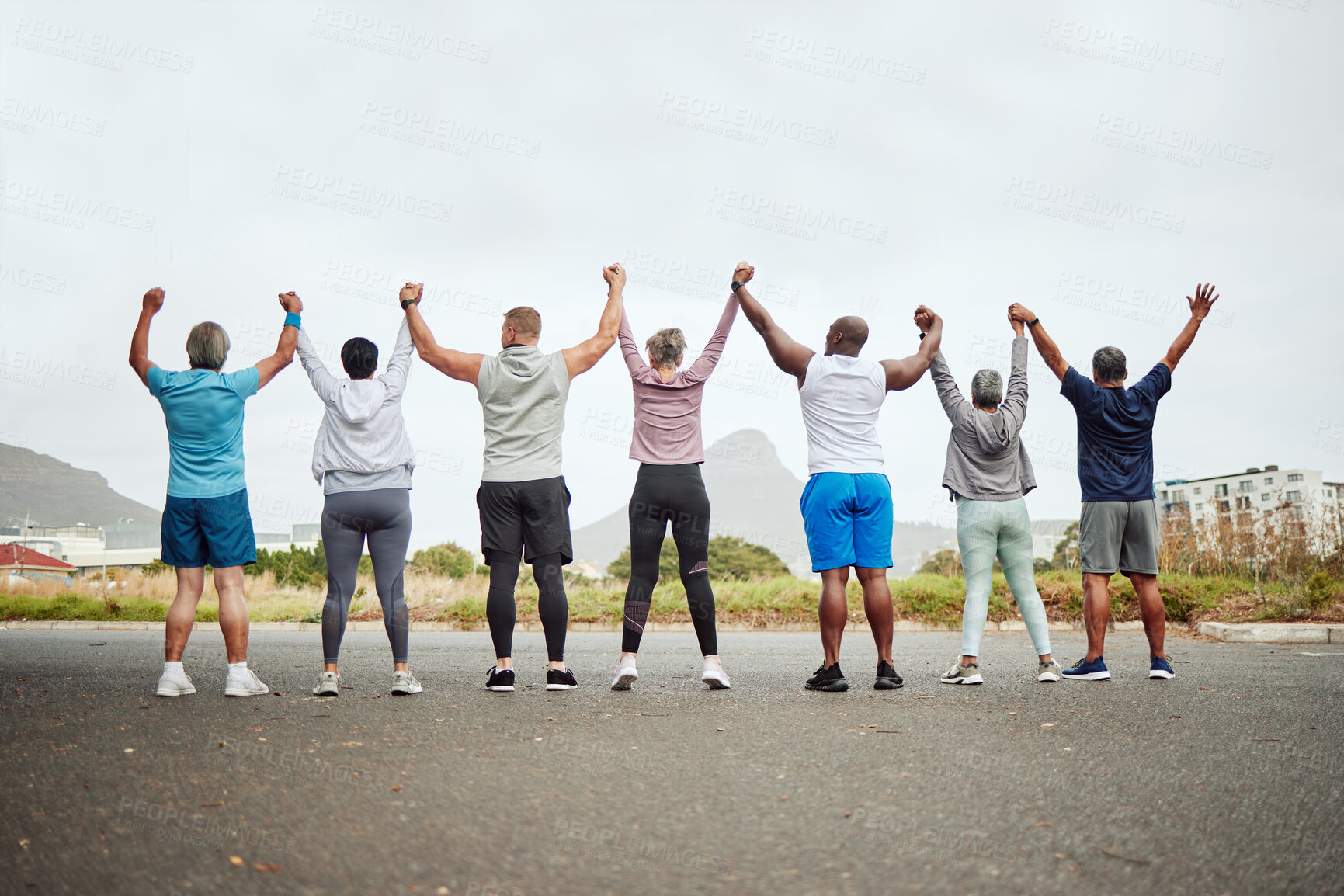 Buy stock photo Holding hands, fitness group of people winning, yes or celebration exercise, workout and training goals in city rear. Wellness, community and senior friends teamwork, accountability and success sign