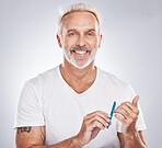 Portrait, nail file and beauty with a man in studio on gray background mockup for grooming, filing his finger nails. Manicure, wellness and cosmetics with a male taking care of his personal hygiene