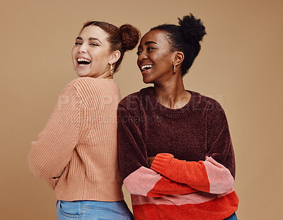 Buy stock photo Happy, smile and women friends in a studio together with fun, freedom and positive mindset. Happiness, excited and interracial girl best friends smiling with style while isolated by brown background.