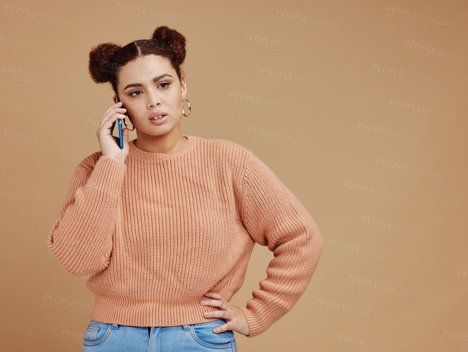 Buy stock photo Phone call, upset and woman in a studio with mockup space during an argument, fight or disagreement. Moody, communication and female model on a mobile conversation while isolated by brown background.