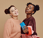 Selfie, friends and women with smartphone, social media and connection on brown studio background. Females, girls and cellphone to share photos, posting and bonding together casual, trendy and smile