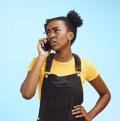 Buy stock photo Phone call, confused and black woman on blue background with spam problem, network and connection. Communication, advertising and girl in conversation, talking and scam with smartphone in studio