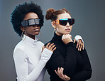 Fashion, futuristic and cyberpunk with women in sunglasses, young and trendy designer brand with gen z youth. Marketing, diversity and future style with vision and edgy against studio background