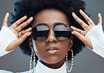 Face zoom, sunglasses and fashion with black woman, style and designer with trendy brand and gen z hands against studio background. Jewelry, edgy and girl, marketing with fashion model and beauty