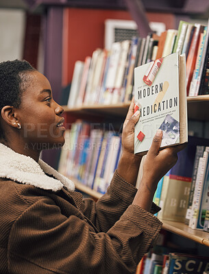 Buy stock photo Black woman with book, student of medicine in library, pills and healthcare education with learning about pharmaceutical drugs. Reading information, learn and study, research for medical exam