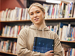 Face, woman and student in university library ready for learning. Education, portrait and happy female from Canada standing by bookshelf with book for studying, knowledge and literature research.