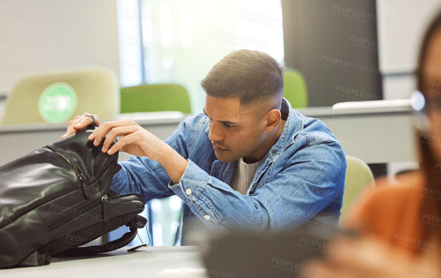 Buy stock photo University student, man and backpack in a classroom for education, studying and learning at campus. Person in class searching for object in bag to learn and study at college, school or campus