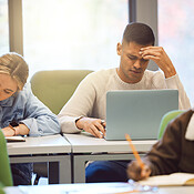 Laptop, stress and man studying, headache and education for knowledge ...