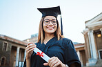 Portrait, graduate and study with a student woman holding a diploma or certificate outdoor on graduation day. Education, goal or unviersity with a female pupil outside after scholarship success