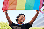 Rainbow, flag and lgbt with an indian woman in the city in celebration of human rights, equality or freedom. Community, support and gay with a gender neutral or non binary female celebrating lgbtq